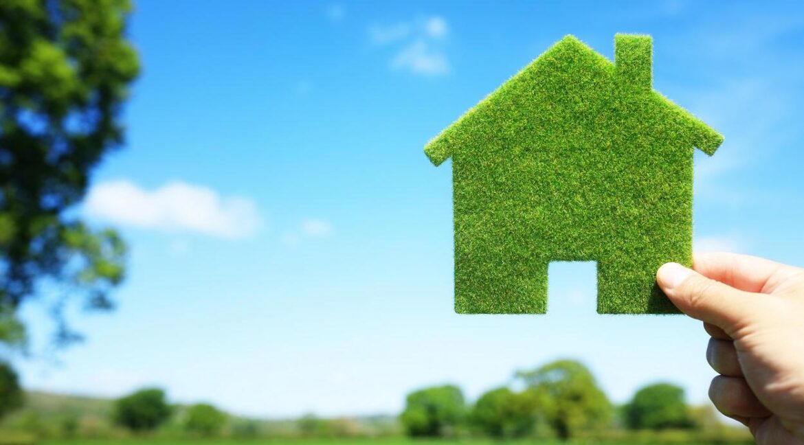 Green ecological house in empty field